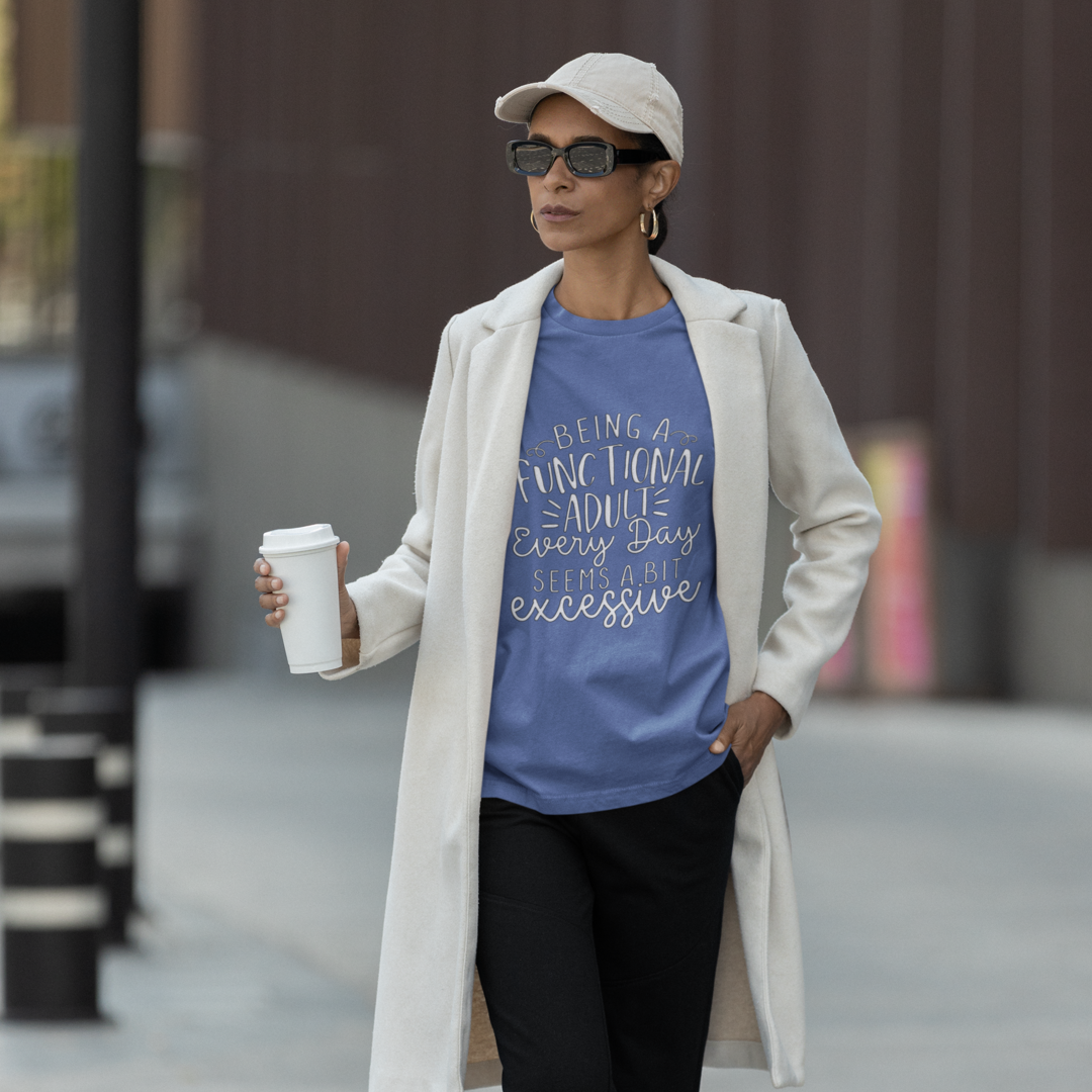 A Woman Wearing a White Trench Coat Holding Coffee Wearing a Crew Neck T-Shirt with Text - "Being a Functional Adult Every Day Seems a Bit Excessive" - True Royal Heather Blue
